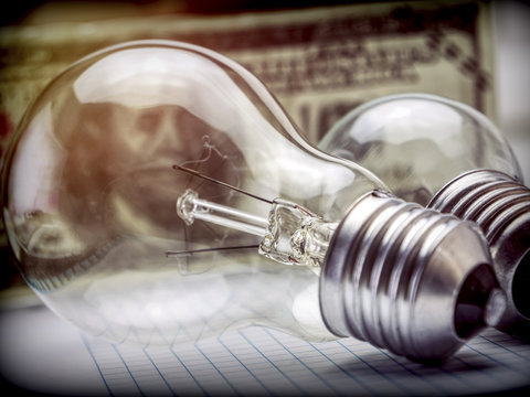 A lightbulb on dollar bill, energy saving concept