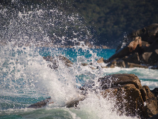 A wave breaking on the rocks.
