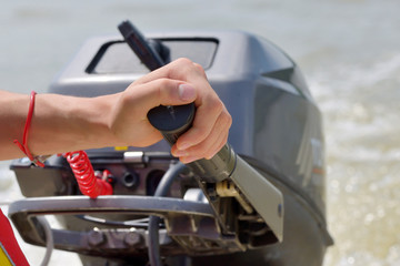 Fisherman hand and boat engine
