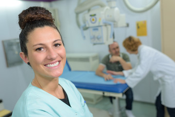 portrait of female nurse standing in hospital corridor