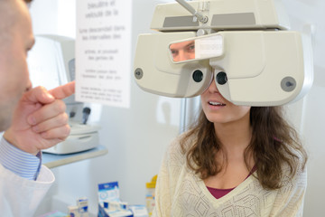 optometrist examining female patient with messbrille in ophthalmology clinic