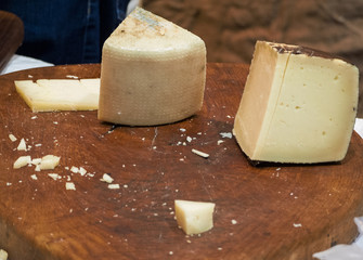 wooden chopping board with cheeses ready to be tasted