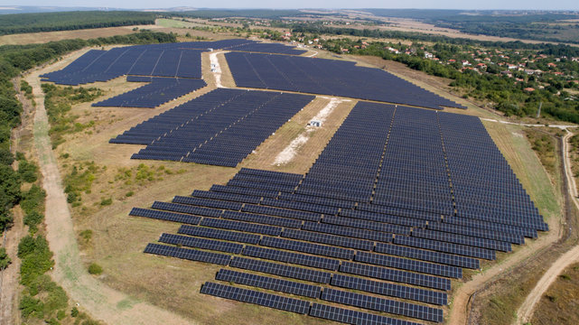 Aerial shot of photovoltaics solar farm. Solar farm power station from above. Ecological renewable energy.