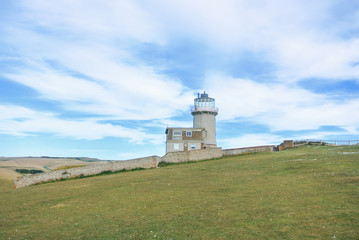 Fototapeta na wymiar Belle Tout Lighthouse on summer cloudy day, Seven Sisters country park, Eastblurne, East Sussex, England, UK.