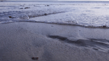 Cold winter morning at the beach, with a receding tide