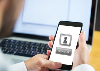 Hand holding phone with feedback buttons