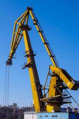 Industrial cranes in port on a background of blue sky