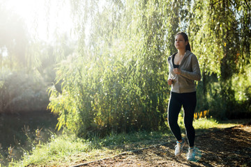 Sporty girl jogging in nature