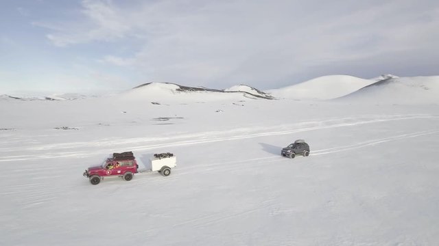 360 aerial, cars drive off road in snowy Iceland aerial