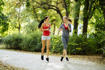 Energetic young women running outdoors