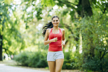 Young beautiful athlete jogging in park