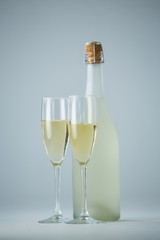 Glass of champagne with champagne bottle