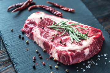 Raw beef steak with fresh rosemary