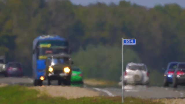 Track. The movement of vehicle on a road. Car traffic. Highway in summer day. Cars on a country road. Cars moving in two directions on highway. 4 k