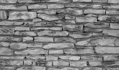 Grey stone wall texture. Ancient natural cobblestone road as background.