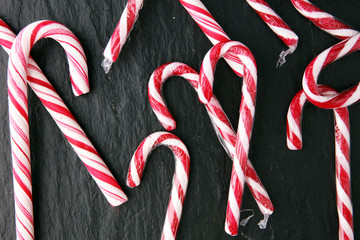 Christmas candy on black board. candy canes for xmas.