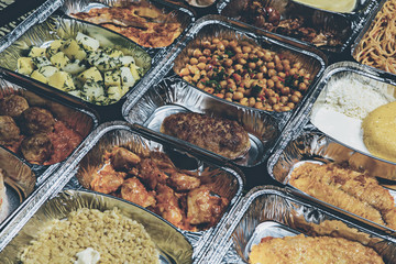 Healthy lunch in aluminum foil package. Top view. Lunch box with food ready to go for work or...