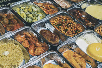 Healthy lunch in aluminum foil package. Top view. Lunch box with food ready to go for work or...