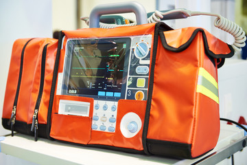 Modern portable biphasic defibrillator - obrazy, fototapety, plakaty