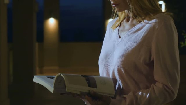 Female reads the journal under muffled light