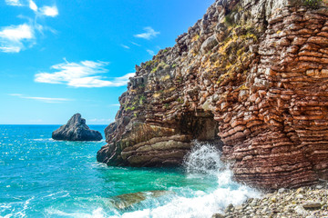 The sea view. Calm sea and large stones. Transparent water of the Adriatic Sea. Montenegro