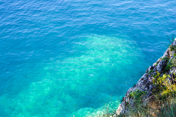 Fototapeta na wymiar Underwater sea stones, surface with ripples, beautiful pattern transparent clear water