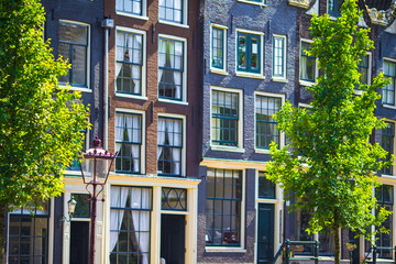 Fototapeta premium Traditional dutch buildings and blocks of flats in in old Amsterdam, Netherlands