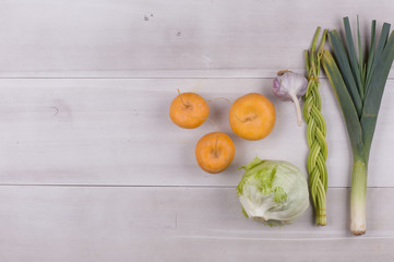 turnips and vegetables on a white rustic table
