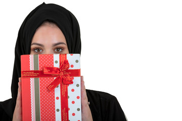 Happy young muslim woman with gift box isolated over white background