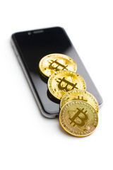Bitcoin lies on a smartphone.