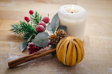 the warmest spirit of Christmas, still life of few symbols of christmas. panettone, tangerine, cinnamon, candle.