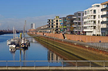 Waterfront of the Europa harbor in Bremen, Germany with moored sailing yachts and modern office and...