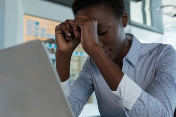 Female executive sitting in futuristic office