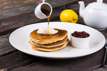pancake with honey on a wooden background