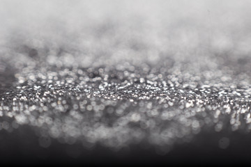 Golden and silver glitter backgound with bokeh abstract blur effect 