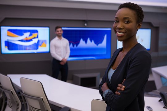 Male and female executives standing in boardroom