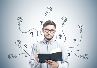 Intelligent young man with a planner, questions