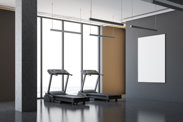 Two treadmills in a gray room corner, poster