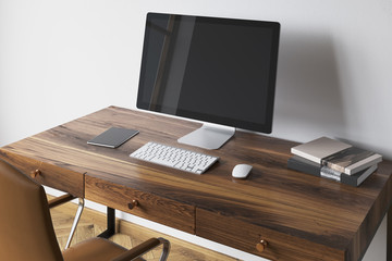 Black computer screen on a dark wooden desk side