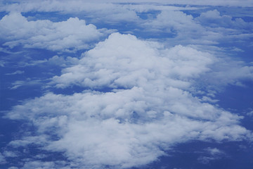 fluffy clouds at blue sky from above top