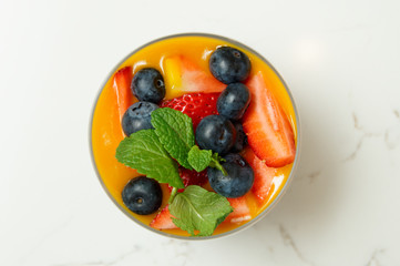 Berry dessert in glass shot from above