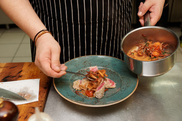Chef is serving fried tuna with vegetables