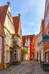 Obraz premium Medieval Bremen street Schnoor with half-timbered houses in the centre of the Hanseatic City of Bremen, Germany