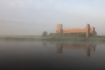 Fototapeta na wymiar Medieval castle in a misty weather, city Kolo, Poland