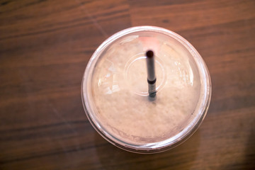 Glass plastic of chocolate cream top view  background