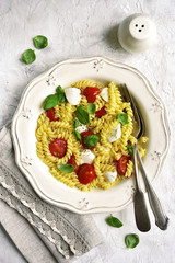 Pasta caprese with tomato,mozzarella and basil.Top view.