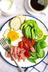 Fried egg,salted salmon,tomato,spinach and avocado - concept of healthy breakfast.Top view.