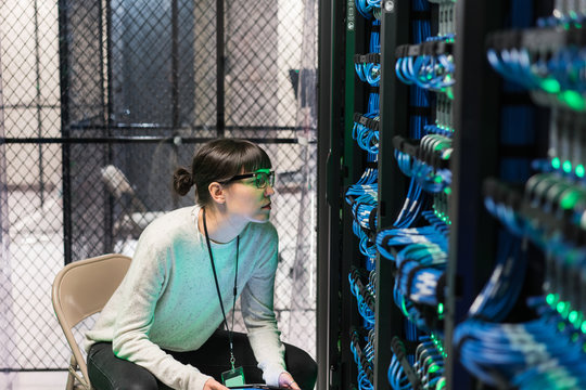 Server room technician with green lit face