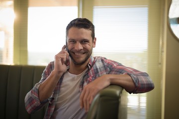 Man talking on mobile phone in restaurant