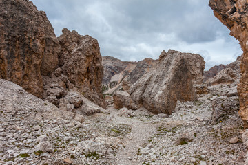 Path in the middle of giant boulders expanse named Masarè. The boulders was transported by ancient glacier and was theater of fierce fighting in 1915 - 16 Dolomites, Italy
